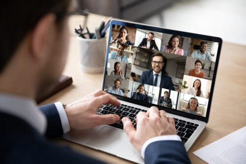 Close,Up,Rear,View,Businessman,Engaged,In,Online,Conference,,Using